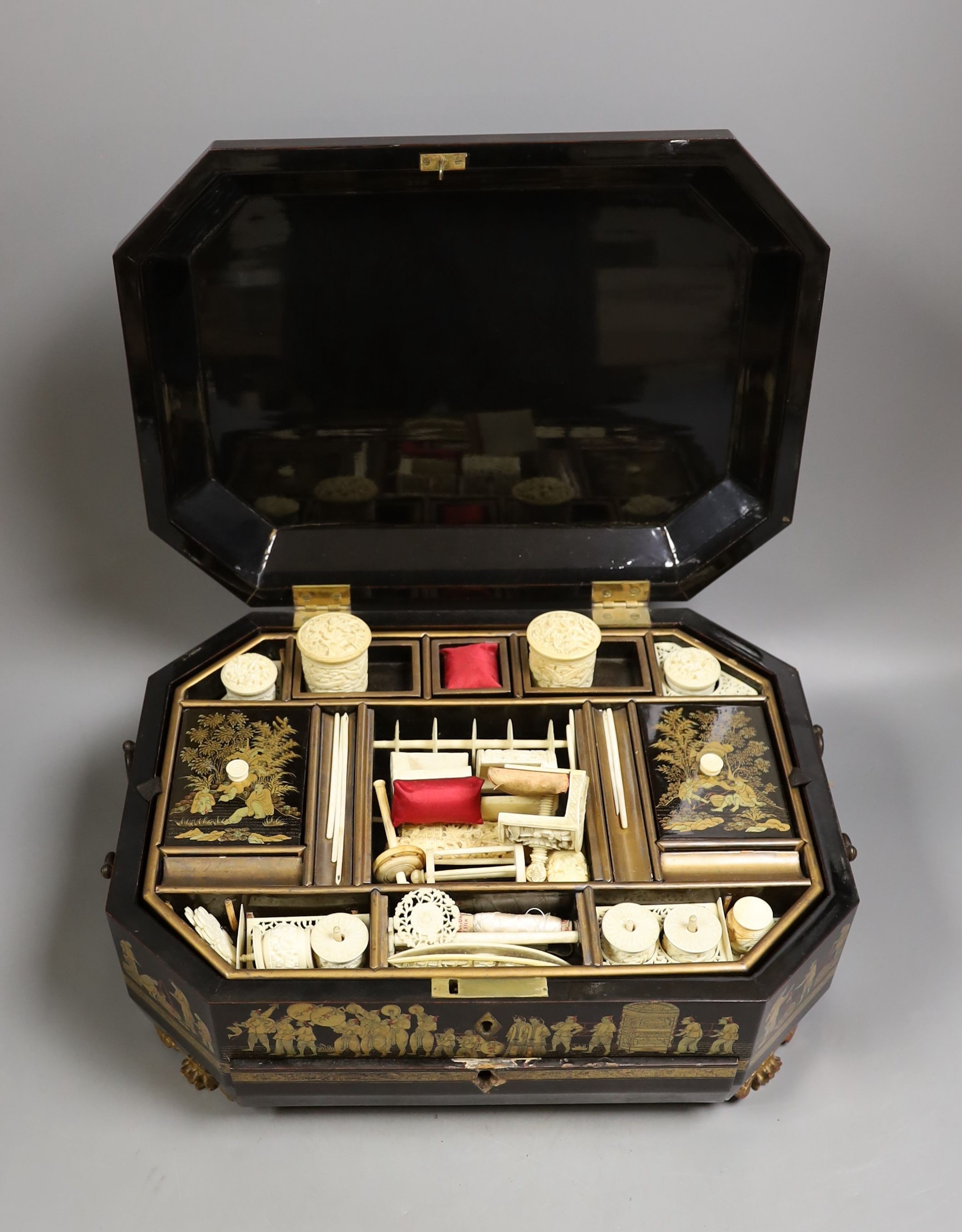 A mid 19th century Chinese Cantonese lacquer workbox with with carved Ivory sewing accessories to the interior, 37cm wide